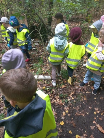 Dzieci chodzą po lesie i szukają odpadów. (3)