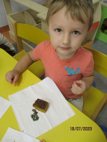 Chłopiec z grupy drugiej podczas degustacji ciasta dyniowego i pestek z dyni